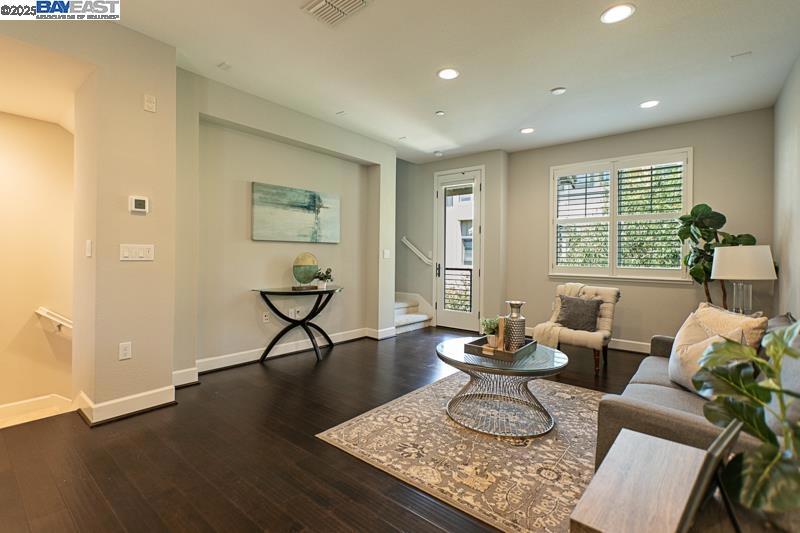 Located in the highly sought-after Sage neighborhood and offering a rare Hillview, this stylish home offers both comfort and convenience. The entry level features a private bedroom and full bathroom, along with a dedicated laundry room. The second floor showcases a spacious open-concept layout that includes a well-appointed kitchen, dining area, and inviting family room. The kitchen is equipped with quartz countertops, an upgraded backsplash, GE Café Series appliances, breakfast bar seating, and modern lighting. The third level offers two additional bedroom suites. Interior upgrades throughout include laminate flooring, upgraded carpeting, mirrored closet doors, built-in storage, plantation shutters, and glass shower enclosures. Additional amenities include a tankless water heater, an electric vehicle charger, and an extra-deep attached two-car garage. Enjoy access to resort-style community amenities, including a pool, clubhouse, gym, park, picnic area, and more. Conveniently located near I-580 and Highway 84, San Francisco Premium Outlets, BART, the ACE Train, shopping, dining, and award-winning wineries.