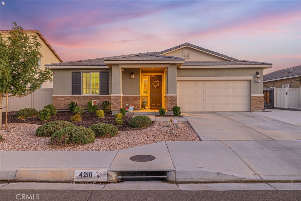 Introducing 4216 W Ivyton St.A beautiful 4-Bedroom Home in Sunset Landing. This stunning single family residence was built in 2018 by Beazer Homes. This thoughtfully designed 4 bedroom, 2.5 bath home combines modern comfort with stylish finishes throughout. As you step inside, you'll notice an open-concept layout, featuring a spacious living area, a large kitchen island with granite counter tops, and a very large walk-in pantry perfect for storage. Vinyl flooring flows seamlessly through the main living spaces and the first bedroom as you enter the house. Cozy carpet finishes the other 3 bedrooms. The Primary Suite, you'll find, is a true retreat with a spa-like en-suite bathroom, complete with dual-sinks. a soaking tub, a separate walk-in shower, and a generous walk-in closet. The guest, full bathroom also offers dual-sinks for added convenience. Enjoy the outdoors with fully landscaped front yard and backyard featuring a grassy area, fully paved side yard, a custom front gate and patio space for entertaining. This energy efficient home comes with Paid Off Solar, a tankless water heater, Beazer Home Fire Suppression, and a Smart Thermostat. The property is also euipped with a wired Ring security system and whole-home wireless internet wiring for modern living. Don't miss your chance to own this move-in ready gem that has been meticulously cared for. Welcome to your new home!