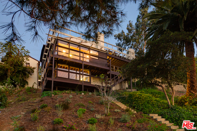Modernist hillside duplex above Silver Lake's Sunset Junction. Designed by architect Edward Richard Lind (a protege of R.M. Schindler), this was Lind's own lifelong family home and he perfectly sited it to capture the stunning views in every direction. The main house is two stories and consists of 3BR and 2BA. The home features floor-to-ceiling glass, vintage details like built-in cabinetry and a sliding shoji door. The open living/dining room's sliders lead out to a large deck with panoramic views. Under the main house is a large 1BR/1BA unit featuring wrap-around windows with views of Griffith Park and the Observatory. One more level down is a detached bonus room that could be used as an office or creative space. Landscaped yard, off-street parking, detached garage with storage. High on the hillside to command sweeping views and provide a neighborhood feel, yet a quick walk to Sunset Junction shops and Silver Lake Farmer's Market. Entire property delivered vacant. A rare opportunity.