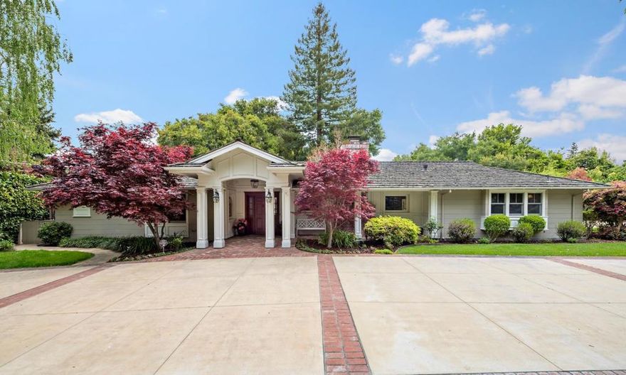 Huge price reduction! This wonderful home is designed to take full advantage of the gardens from almost every room opening out to the beautiful wrap around covered lanai, perfect for outdoor living. The living room features French doors opening to lovely patio and gardens. The living room offers a wall of custom built-ins integrated fireplace and coffered ceiling. The gourmet kitchen is equipped with high-end appliances, beautiful antique glazed cabinetry, granite counters and a large center island with sink and eating area. The Primary bedroom is extremely large with walk in closet, sound system, fireplace and doors to the garden. 2 of the additional bedrooms are ensuites and the other two share a bath. One bedroom is currently used as an office/family room. The generous back yard is perfect to enjoy outdoor sports and still allows for an ADU in a non obtrusive area. The sparkling pool is fences w/lovely lanai and gardens in a resort like setting. Excellent school district.