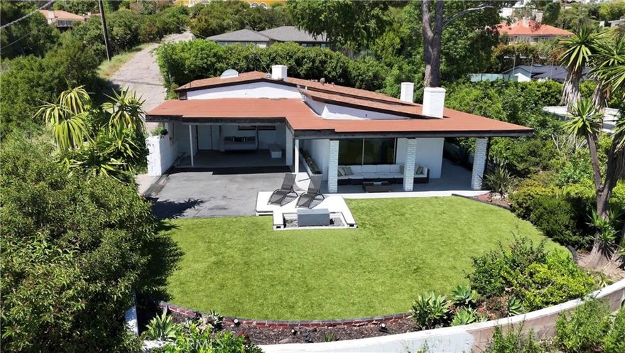 An exceptional value in BHPO. Attention Mid-Century modern enthusiasts and developers: Discover the perfect blend of architectural heritage and development potential at 9924 Beverly Grove Drive, a historic mid-century modern home for sale in Beverly Hills, perched atop a scenic knoll in the prestigious Beverly Hills Post Office. Surrounded by some of LA's most high-profile residents, including LeBron James, Lisa Kudrow, and Kylie Jenner, this star-studded enclave offers both prestige and privacy. Privately tucked away on a private road, this rare single-story residence offers breathtaking panoramic city views, exceptional privacy, and timeless design. Spanning approximately 2,582 square feet, the home features three spacious bedrooms, three bathrooms, and a striking indoor pool that creates a peaceful, spa-like atmosphere at the center of the home. The expansive living room was thoughtfully designed to take full advantage of the sweeping city views, offering a bright and open space ideal for both everyday living and entertaining. Set on nearly half an acre of prime Beverly Hills real estate, this historic mid-century property offers endless potential, whether for restoration or transformation. A pre-development study by a renowned Los Angeles architect outlines plans for a 5,300-6,000 sq ft estate across three levels. Developers may also benefit from the potential to lift current deed restrictions, opening the door to merging with adjacent parcels for expanded development opportunities. The current layout also presents cost-effective opportunities to expand the home's footprint and bedroom count, making it ideal for a developer or end user looking to maximize value in a highly sought-after location. Whether you're looking to restore a classic or build a luxurious custom estate, 9924 Beverly Grove Drive presents a rare opportunity to own a mid-century modern home with panoramic city views, exceptional privacy, and one of the few indoor pools found in Beverly Hills real estate offering a truly unique blend of architectural charm and lifestyle potential in the prestigious BHPO.