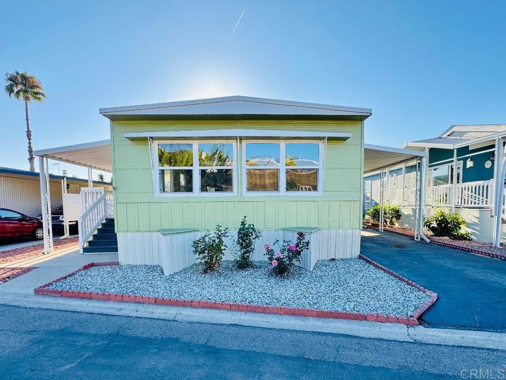 Welcome to Leisureland #118. This move-in ready residence offers 3 bedrooms and 2 full bathrooms on a generous lot featuring a porch, patio area, carport, and mature fruit trees. The home is situated within the well-maintained and highly sought-after Leisureland Mobile Villa, a centrally located 55/18 Senior Community where homeowners must be at least 55 years old, and other residents may be 18 years of age or older. The property includes a kitchen equipped with a stove, microwave, and ample cabinetry, a dedicated dining area with a custom-built hutch, a spacious living room, included washer and dryer, a primary bedroom with an ensuite bathroom complete with walk-in shower, dual pane windows throughout, a low-maintenance yard, storage shed, and additional features. Leisureland Mobile Villa is currently undergoing a building enhancement project that will introduce an upgraded clubhouse with a kitchen, card room, billiard room, shuffleboard, and pool. The community is conveniently located near grocery stores, shopping centers, restaurants, banks, the post office, public transportation, and major freeways. Resident-planned activities are available, and common areas are carefully maintained, including a large laundry facility with commercial-grade washers and dryers, a library/game room, clothes-line drying area, and a resident-tended garden area. Spanning a private and secluded 23-acre setting adjacent to The Chollas Open Space Trails, Leisureland offers both serenity and convenience. Do not miss this opportunity to own an affordable home in an exceptional location! Contact us today to schedule a private showing.