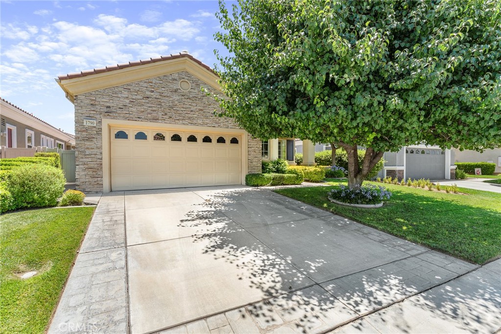 Popular "Trillion" model located in Solera Oak Valley Greens, a 55+ gated community. This lovingly maintained home is move-in ready. From the moment you enter, the vaulted ceilings and 8 ft. doors create an open and inviting atmosphere. Kitchen features stainless steel appliances, granite countertops and plenty of storage space. All appliances are included, making for a seamless move-in experience. The spacious open floor plan is perfect for entertaining guests or enjoying cozy evenings by the fireplace. The primary suite features both a walk-in shower and a soaking tub. A versatile office or third bedroom provides extra flexibility. The lush garden and picturesque backyard are truly breathtaking. Creating your own private oasis. The garage has an extra nook, perfect for a workbench or extra storage, plus plenty of cabinets and overhead shelving. Solera has a clubhouse, pool, spa, gym, indoor walking track, tennis courts, bocce ball, clubs to join, classes, and group trips. HOA includes basic Spectrum cable and internet. Conveniently located near Palm Springs, Redlands, Cabazon Outlets, Morongo Casino, and top golf courses, with quick access to the 10 fwy. Original owners for 20 years. This home is truly special!