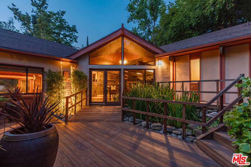 Welcome to 1064 Meadows End A One-of-a-Kind Architectural Sanctuary in Monte Nido's Coveted Malibu Canyon Neighborhood.Tucked at the end of a quiet cul-de-sac and framed by ancient sycamore and oak groves, this beautiful single-level home offers a rare blend of refined design and natural beauty. Set on just over an acre of mostly flat, park-like grounds, this property is a true staycation retreat private, peaceful, and surrounded by nature. Step through the serene entry with black flagstone pavers complete with a koi pond, and into an expansive, light-filled interior crafted with meticulous attention to detail. French Oak floors flow throughout, while dramatic wood-beamed ceilings and a striking four-sided fireplace anchor the open-concept living space. A wall of French doors seamlessly connects indoors to the entertainer's dream backyard, flooding the home with natural light and bringing the outside in. The chef's kitchen is a statement in both function and form featuring concrete countertops, top-tier appliances with double oven, warming drawer, ice machine, Sub Zero Refrigerator & Freezer, two dishwashers and custom cabinetry complete this fabulous kitchen. Skylights illuminate the adjacent dining area. A flexible floor plan offers 4 bedrooms, and 4 bathrooms ensures optimal privacy for guests, with well-separated secondary bedrooms. The newer primary suite is a sanctuary of its own, offering custom built-in cabinetry, soaring ceilings, French doors that welcome morning light, and a luxurious bath with a soaking tub and heated floors. A step-down family room leads out to a spectacular pool oasis designed by renowned landscape architect Nick Williams & Associates complete with a rock waterfall and lushly landscaped surroundings. The back 4th bedroom could serve as additional den / office with oversized closet / art or hobby room. The unique stone wall 3/4 pool bathroom opens to outdoor shower and private garden. Wander through flowering gardens and along meandering paths beneath majestic oak trees. Enjoy a rose garden, fruit trees and charming chicken coop, and plenty of flat usable land perfect for outdoor entertaining, quiet reflection, or simply soaking in the beauty of this magical setting. Additional features include 3 tankless water heaters, Dual Zone HVAC system, new Generator 2024 and a new roof in 2025. Ideally located just minutes from Malibu Creek State Park's hiking trails, the vibrant restaurants, shops and beaches of Malibu. Calabasas Commons, and the 101 Freeway. Situated in the award-winning Las Virgenes School District, this is not just a home it's a lifestyle. A rare architectural gem where nature meets design. A truly magical retreat.