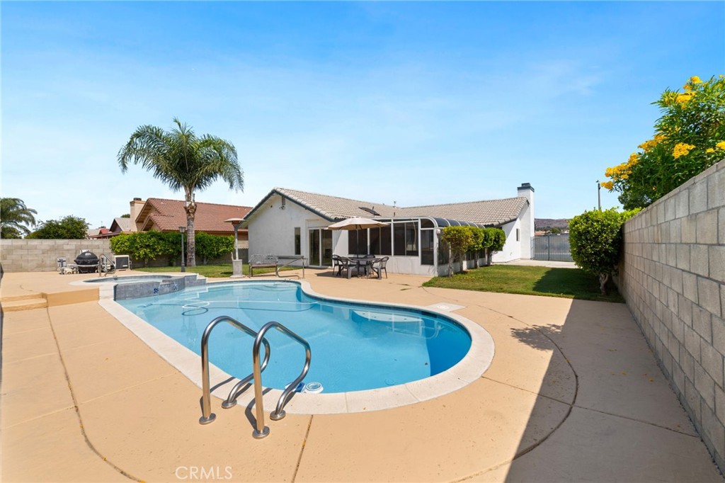 Charming Single-Level Pool Home with Sunroom & RV Parking. Discover this beautifully updated three-bedroom, two-bath home featuring a smart, single-level floor plan designed for comfort and convenience. Perfect for entertaining, the spacious and private backyard offers a sparkling pool and spa, with seamless access to an expansive sunroom—ideal for year-round enjoyment. Additional highlights include a two-car garage, dedicated RV parking, and recent upgrades such as fresh interior and exterior paint and newly resurfaced pool plaster. Situated in a prime location near the 60 and 215 freeways, this home is just a short walk to K-12 schools, Kaiser Permanente, and a variety of shopping and dining options. Move-in ready and packed with potential—don’t miss this opportunity!