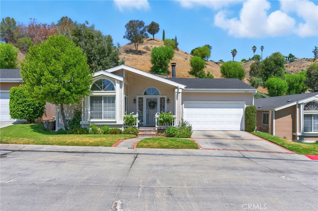Welcome to this thoughtfully upgraded land lease home located in the desirable Canyon View Estates, a secure guard-gated community offering comfort, style, and convenience. After the foyer, step into a spacious great room featuring fireplace, high ceilings, new laminate flooring throughout, and a sliding glass door leading to the serene backyard. The open-concept layout flows seamlessly into the modern kitchen, boasting granite countertops, subway tile backsplash, stainless steel appliances, and a center island—perfect for gathering and entertaining. Enjoy your morning coffee in the cozy breakfast nook, overlooking the landscaped front yard. The primary suite is generously sized and offers custom automatic blackout shades, closet organizers, and direct access to the backyard. The remodeled en-suite bathroom showcases dual floating sinks, a soaking tub, and a spa-style shower with a sleek barn door. Two additional bedrooms also feature new laminate flooring, with one including built-in closet organizers. The second full bath has been tastefully remodeled to match the home’s cozy modern look. Step outside to your private backyard oasis, complete with ample shade, spa, plenty of grassy space, and mountain view backdrop—ideal for relaxing or entertaining. Additional upgrade include: new garage door opener, new security front door, new ceiling fans, and new lighting. Community amenities are 24 hour gated access, 2 pools and spa, 2 sports courts, 2 play areas, clubhouse, and RV storage. Conveniently located near bike and walking paths, close to parks, shopping, schools, and entertainment.