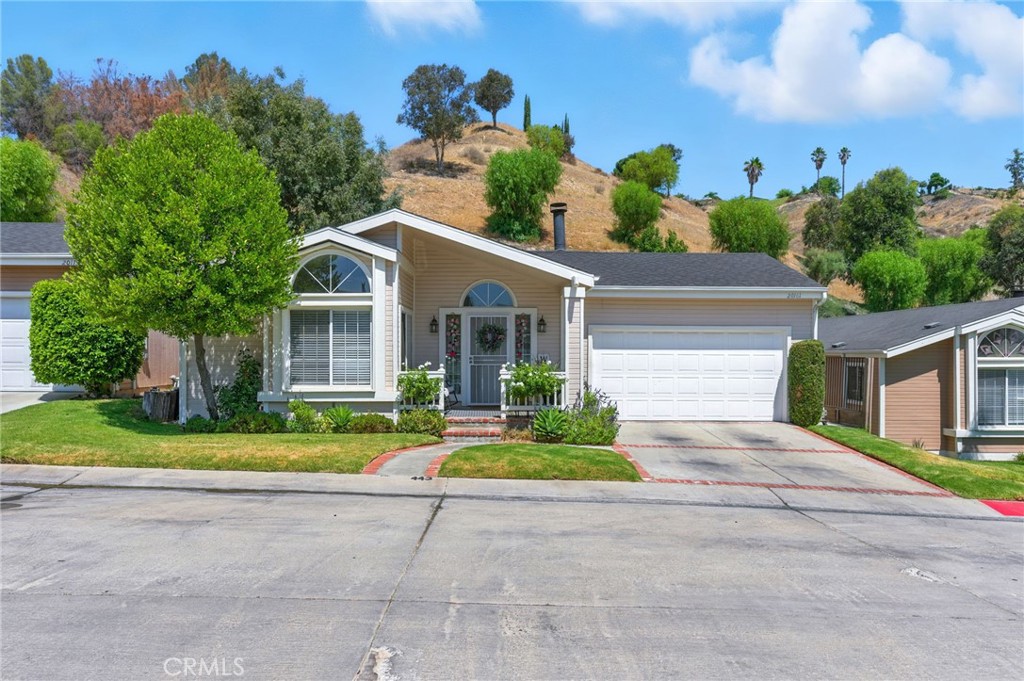 Welcome to this thoughtfully upgraded home located in the desirable Canyon View Estates, a secure guard-gated community offering comfort, style, and convenience. After the foyer, step into a spacious great room featuring fireplace, high ceilings, new laminate flooring throughout, and a sliding glass door leading to the serene backyard. The open-concept layout flows seamlessly into the modern kitchen, boasting granite countertops, subway tile backsplash, stainless steel appliances, and a center island—perfect for gathering and entertaining. Enjoy your morning coffee in the cozy breakfast nook, overlooking the landscaped front yard. The primary suite is generously sized and offers custom automatic blackout shades, closet organizers, and direct access to the backyard. The remodeled en-suite bathroom showcases dual floating sinks, a soaking tub, and a spa-style shower with a sleek barn door. Two additional bedrooms also feature new laminate flooring, with one including built-in closet organizers. The second full bath has been tastefully remodeled to match the home’s cozy modern look. Step outside to your private backyard oasis, complete with ample shade, spa, plenty of grassy space, and mountain view backdrop—ideal for relaxing or entertaining. Additional upgrade include: new garage door opener, new security front door, new ceiling fans, and new lighting. Community amenities are 24 hour gated access, 2 pools and spa, 2 sports courts, 2 play areas, clubhouse, and RV storage. Conveniently located near bike and walking paths, close to parks, shopping, schools, and entertainment.