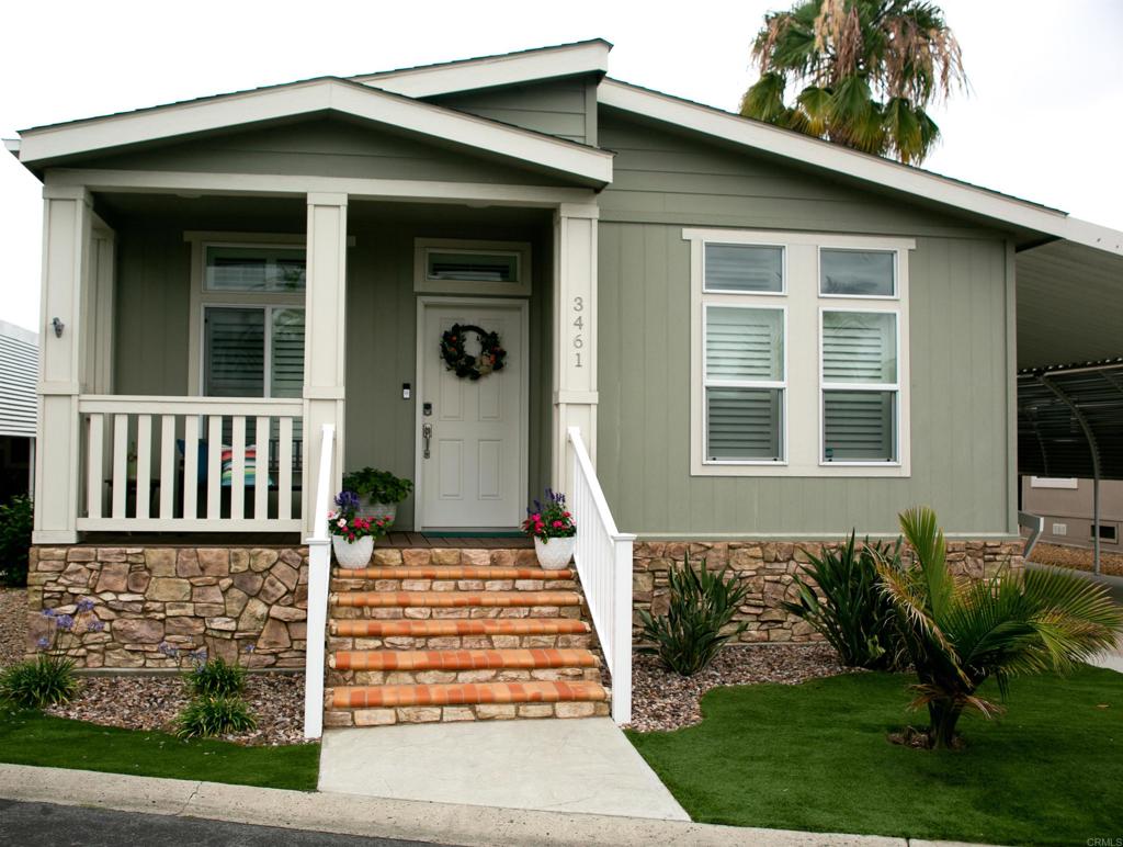 Welcome to a beautifully & meticulously maintained home located in the resident-owned, guard-gated 55+ Rancho Carlsbad Community. This move-in ready home, built in 2020, offers 1,495 square feet of spacious living with an open-concept floor plan & an abundance of natural light throughout, all with a relaxing coastal feel. The spacious kitchen features a large island with seating, ample cabinet storage, stainless steel appliances, extra recessed lighting, & a dining area that's perfect for hosting. this area flows seamlessly into the expansive great room- ideal for entertaining family & friends. The home is loaded with upgrades including vinyl plank flooring, plantation shutters, vinyl dual-pane windows & crown molding. The large primary suite boasts a walk-in closet & a private en-suite bathroom with a spa-like ambiance. There are two additional bedrooms- one currently set up as a home office & the other ideal for guests. Next to the second bedroom is a spacious guest bath. Step outside to the outdoor seating area- perfect for enjoying your morning coffee, unwinding in the evening, or simply soaking in the peaceful surroundings of this resort-style community. Or sit at the outdoor seating area in the back around your fire pit, perfect for cozy evenings, entertaining guests, or enjoying the coastal night sky. Designed with accessibility in mind, the carport includes an ADA-compliant 36" non-skid Trex ramp leading to the side door entry. The location of this home is ideal- just a short walk to the pool, clubhouse & gym. You'll also enjoy resort-style amenities such as tennis & pickleball courts, a dog park, bocce ball, gardening plots, plus more than 30 different clubs to choose from. Rancho Carlsbad is located near shopping, fine dining & beautiful beaches. Experience the best of active senior living today!