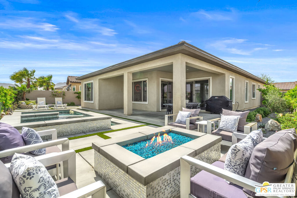Modern Desert Oasis in 55+ Del Webb Rancho Mirage! Welcome to The Preserve Model-- a stunning 2-bedroom, 2-bath + Den/Office home that's been completely reimagined with a fun, modern flair! Spanning 2,008 sq. ft., this stylish retreat boasts all-new large grey Italian floor tile and plush carpeting, plus French doors that add elegance and privacy to your office or creative space. Step outside to your private entertainer's paradise-- a sparkling saltwater pool and spa, a built-in fire pit, and lush landscaping with fruit trees. Whether you're hosting lively gatherings or enjoying a peaceful evening under the stars, this backyard is a dream come true! With leased solar @ just $139/month, energy efficiency is effortless. Plus, as part of Del Webb Rancho Mirage, you'll enjoy resort-style amenities including a state-of-the-art fitness center, clubhouse, bar & lounge, tennis courts, and pickleball-- all in the heart of prestigious Rancho Mirage! This modern gem is close to Aqua Caliente Casino/ Spa, Acrisure Arena, Mission Hills CC, restaurants. Ready to experience the best in 55+ luxury living? Call today for a private showing. Photos don't show updated lighting fixtures over kitchen island and entry.