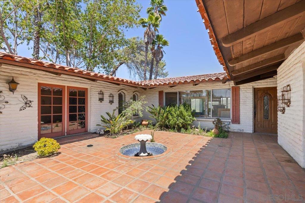 Perched on a scenic hilltop, this expansive 5.12-acre property features 2 units. A main house and a guest house with breathtaking views to the east and west. The main house offers 2 beds, 2.5baths, and spacious living areas opening to a patio overlooking a large pool. A second 2-bed, 1-bath home boasts Spanish tile, updated kitchen, and rental income potential. Large horse corral included. With room for expansion and TLC needed, envision creating your dream estate with space for outdoor entertainment and potential amenities like a vineyard or orchard. Conveniently located near freeways 15 and 78, and close to Temecula wine country and Lawrence Welk Resort, seize the opportunity to make this versatile property yours. Septic recently updated.