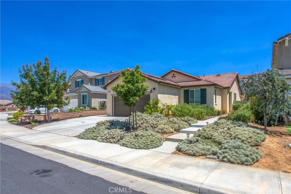 Welcome to the beautiful gated community called Olivewood You will fall in love with this Beautiful 1 story home with open concept!!! The home consist of upgraded quartz counters in kitchen and both bathrooms, upgraded flooring throughout, upgraded interior paint, plus wainscoting, large covered patio, concrete on both sides of the home, concrete stairs front of the yard leading to the front door and save on electric bill because SOLAR is PAID OFF!!!!