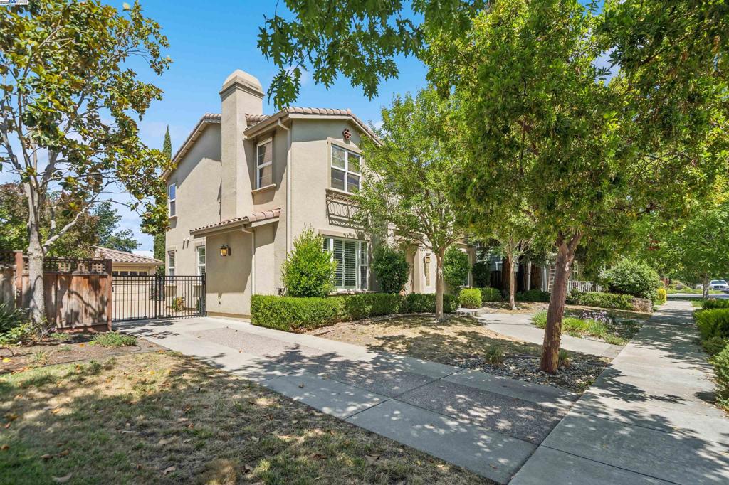 Elegant former model home in Livermore Wine Country! 6 bedrooms and 4 baths, 2 stories house. Bright living room with fireplace and lofty ceiling. Superb family room with door to the patio. Gourmet kitchen featuring gourmet kitchen w/slab granite counters and over-sized island, commercial top-of-the-line appliances w/custom paneling on fridge and new dishwasher, maple cabinets, wood floors, Italian glass dining room fixture, custom designed indoor decorative iron gates. Romantic master suite includes walk-in closets; the luxurious master bath features stone finishes, a large soaking tub, and separate shower. Attractive formal entry. Tiled laundry room. Interior features include wood floors, two fireplaces, recessed lighting installed. Two central air conditioning and two heating zones. 3 detached car garages and spacious guest parking. Truly magnificent. Meticulously water- saving landscaping, professional landscaped yard, sparking swimming pool with energy-saving filter pump. Convenient location, close to 680, 580, and downtown shopping centers. Outstanding Livermore School District.
