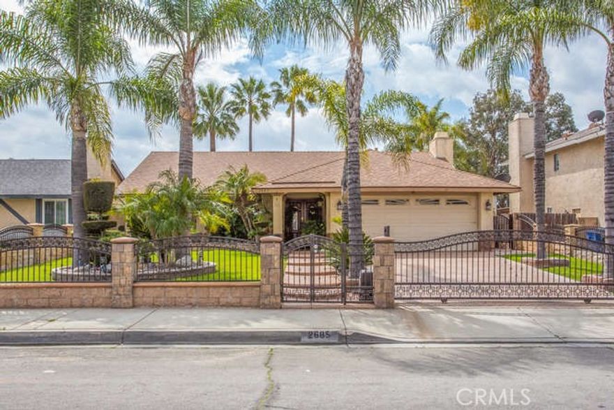Oh my word!!! Have you been looking for a stunning executive style, single story home, close to everything to call your own??? Then PLEASE come and see this beauty. Located within a stone's throw from the High, Middle and Elementary schools, and also just a few short minutes from Arrowhead Regional Medical Center, churches, shopping and dining, this is the definition of "centrally located". From the minute you pull up to this beauty, the curb appeal is immediately impressive. The front gate is remote controlled, with elegant combination of ironwork and stone fence. Inside the fence, the well manicured front yard invites you to come on in, up the stamped walkway to the impressive double doors. Step inside to this welcoming home which has been upgraded in every imaginable way. From genuine hardwood floors throughout, to elegant crown molding in every room, as well as plantation shutters throughout. The beautiful kitchen is sure to inspire even the shyest of cooks. In the winter, relax by the impressive fireplace with a beautiful granite and wood surround.... Both bathrooms have been beautifully updated and features floor to ceiling tile and beautiful granite counters. Through the side french doors off the kitchen, you're led to an entertainer's paradise out back. The stamped concrete and tiled back yard has a patio cover that runs the entire width of the house, and features an outdoor kitchen with custom barbeque grill, sink, tortilla plate and much more. No expense has been spared on this beauty, so come and make it your own today, you'll be so glad you did!!!