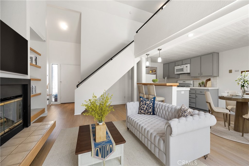 Welcome to a unique blend of modern charm and laid-back California living. Tucked within a quiet and well-maintained complex, this 1-bedroom, 1-bathroom loft-style condo offers an inspired space perfect for students, professionals, investors (very good income potential), or anyone dreaming of calling San Luis Obispo home. Step inside to discover fresh paint and new flooring throughout, enhancing the light and airy feel created by soaring vaulted ceilings, architectural windows, and natural light that pours into every corner. The living room is both inviting and functional, anchored by a stylish fireplace framed with fabulous shelving—ideal for showcasing your favorite books, art, or greenery. A seamless flow guides you to the private outdoor patio, offering the perfect spot for a morning cup of coffee or evening wine under the stars. Upstairs, the lofted bedroom features a dramatic pitched ceiling and a large custom window, creating a bright and cozy retreat with just the right amount of separation. Whether you're winding down from a busy day or tackling a focused work-from-home session, this space offers versatility and peace. The efficient kitchen provides ample cabinetry and countertop space, with easy access to the open-concept dining and living areas. The full bathroom is clean and updated, and there's even a laundry room on site for added convenience. Outside your front door, you’ll find newly refreshed landscaping that complements the lush greenery of the community, assigned parking, and a peaceful, well-kept environment. And best of all? The local bus stop is located right in front of the complex! You’re just minutes from downtown SLO, Cal Poly, Laguna Lake trails, Farmers Markets, 10 miles from the beach, and all the dining, shopping, and culture this beloved Central Coast town is known for. Make it your own! Some images have been virtually staged to help illustrate the home’s potential. All information provided is deemed reliable but not guaranteed. Buyer and Buyer’s Agent are advised to independently verify all information, including but not limited to square footage, lot size, and condition of the property.