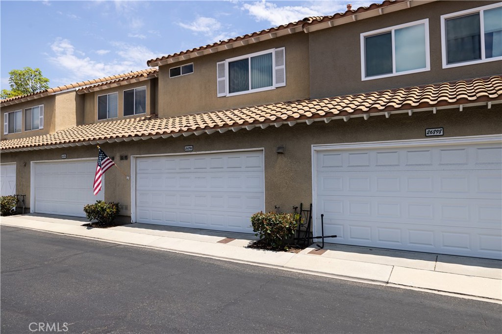 This two-story townhome in Emerald Pointe offers the perfect balance of privacy and community amenities in a prime Mission Viejo location. Arrive to your 2-car attached garage with ample guest parking and a sunny, fenced front patio overlooking lush community landscaping. Inside, the light and open living area features a fireplace and a bay window, flowing into the dining area with bar countertop perfect for casual bites and conversation. The kitchen has a thoughtful layout with granite countertops and gas range. The lower level also includes a powder bath and direct garage access. Upstairs, two spacious bedroom suites each offer vaulted ceilings, generous closets, and private ensuite bathrooms. This layout provides larger suites than the 3-bedroom units in the neighborhood. Outside, your secluded patio is perfect for grilling and relaxation, with two community pools close by. Enjoy Lake Mission Viejo privileges including hiking, fishing, boating, and concerts in the park. Top-rated schools including Carl Hankey K-8 less than a mile away. Easy access to local dining, cafes, groceries, The Shops at Mission Viejo, parks, and hiking trails. An outstanding opportunity!