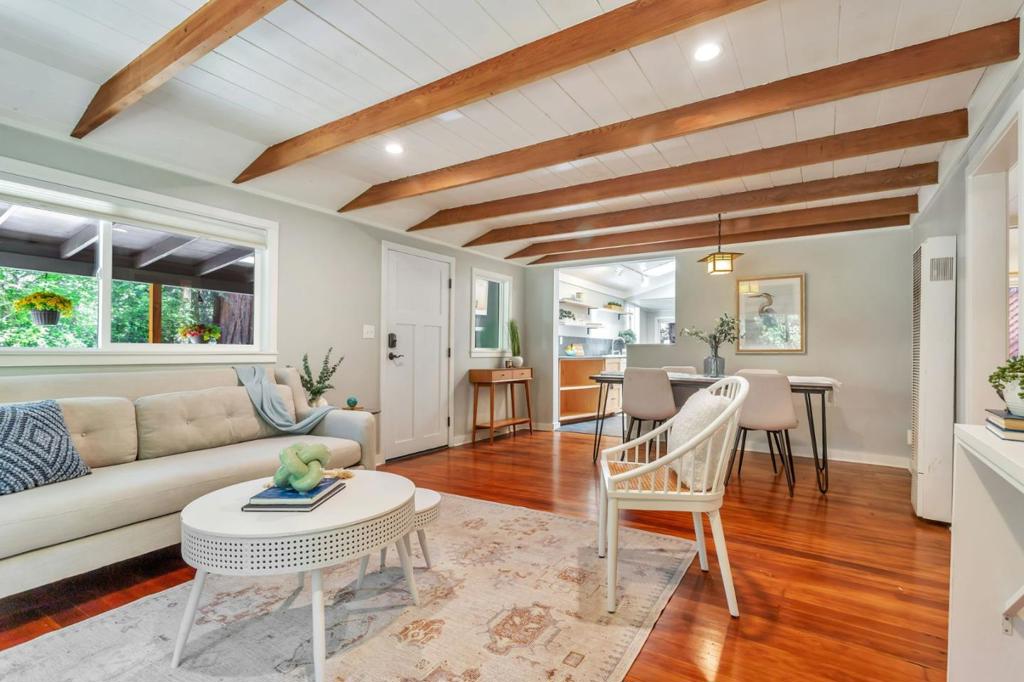 Super charming Ben Lomond home - this can be your place to truly relax and enjoy the Santa Cruz mountains & redwoods. This home was extensively remodeled circa 2019 and features gorgeous wood floors, exposed beam ceiling in the living room, skylights & double paned windows. Enjoy coffee on your inviting covered front porch and take in the views of the trees. The main bedroom has it's own private balcony, high ceilings & cork floors. The bonus room has brand new carpet, skylight and lots of windows to let in the light. The kitchen features a gas stove, skylight and plenty of counter space. There is a nook in the kitchen that has been used as a great office area. Under the home you will find a workshop area and extra storage. This is a charming retreat home with modern updates. Welcome home!