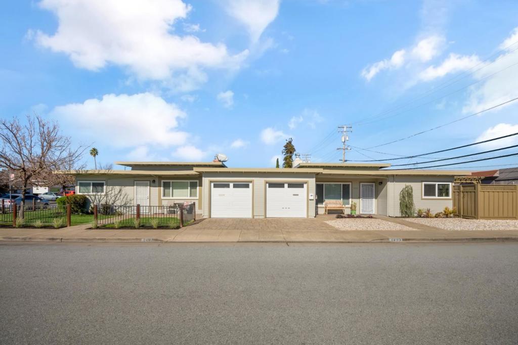 1401-1403 Cary Avenue in San Mateo is a well-maintained duplex situated on a spacious 5,479 SF lot, offering an excellent investment or owner-occupant opportunity. Built in 1950, the property features two updated units: a vacant 3-bedroom, 1-bathroom unit and an occupied 2-bedroom, 1-bathroom unit generating $3,300 per month in rental income. Both units have been thoughtfully upgraded with modern kitchens and bathrooms, providing contemporary comfort while maintaining the charm of the original construction. Each living room is highlighted with 12-foot ceilings and traditional fireplaces. With tenants responsible for all expenses, this property presents a low-maintenance income-producing asset in a desirable location.