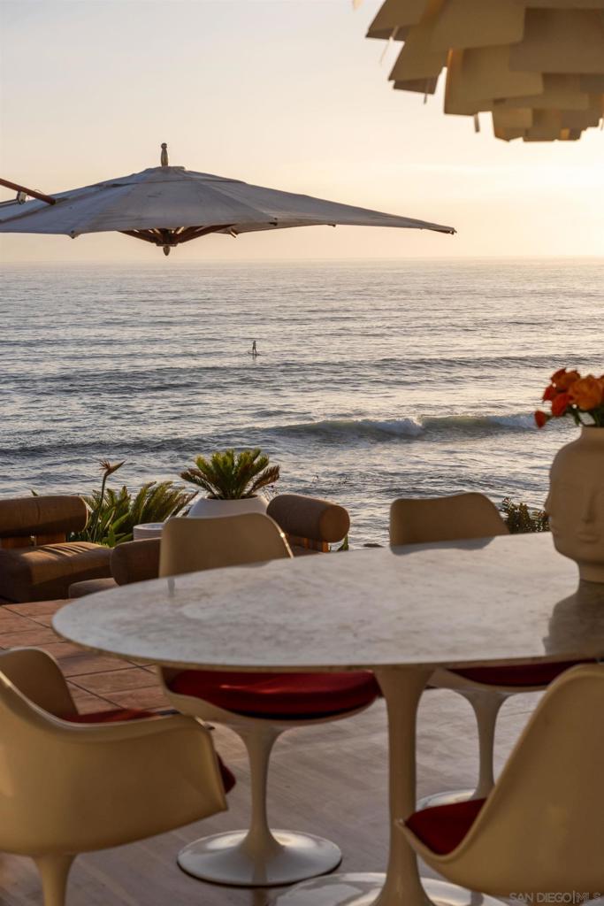 Offered for the first time, the most iconic oceanfront home in all of Carlsbad—an authentic Italian-inspired villa where timeless elegance meets rare beachfront ownership. Nestled within the coveted Terramar community, this extraordinary 6 bedroom estate offers a once-in-a-lifetime opportunity to not only live at the edge of the Pacific but to own the beach itself. Wake up to the sound of waves lapping just beyond your terrace and enjoy sun-drenched mornings with ocean breezes and panoramic coastal views. Designed for luxurious coastal living, the home features dual oceanfront primary suites, including one with a lavish “See to the Sea” oversized shower. A separate 2 story private-entry casita with ocean views adds flexibility for guests, multigenerational living, or income potential. Inside the gated entry, you’re greeted by a lush, romantic courtyard with a bubbling fountain, pond, colorful bougainvillea, and a stunning curved fireplace—setting the tone for the charm and serenity found throughout. Multiple garden vignettes and inviting outdoor seating areas create the feel of a boutique resort, ideal for quiet reflection or entertaining by the sea. Rich wood floors, graceful architecture, and expansive, light-filled living spaces complete the interior, blending old-world character with modern comfort. Voted Home of the Year in 1991 by San Diego Home and Garden, this landmark property isn’t just a residence—it’s a coastal legacy. Live the lifestyle others only dream about—beauty, privacy, and unforgettable oceanfront memories await.