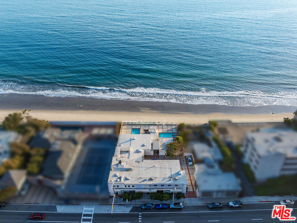 Discover the potential of this one-of-a-kind mid-century property on Malibu's prestigious Carbon Beach, offering 100 feet of sandy beach frontage and breathtaking whitewater views. Situated on approximately half an acre, this property is poised for transformation with conceptual plans for a stunning new architectural estate of grand proportions. The property currently includes a main residence, three guest apartments, three storefront offices, two swimming pools, and two pool houses. This property represents an unparalleled opportunity to reimagine and redevelop this prime Malibu location. The beachfront pool decks, expansive motor court, and three garages provide an ideal canvas for creating a bespoke luxury estate. This is a rare chance to bring your vision to life in one of Malibu's most coveted neighborhoods. Perfect for developers or those seeking to craft a legacy estate on Carbon Beach.