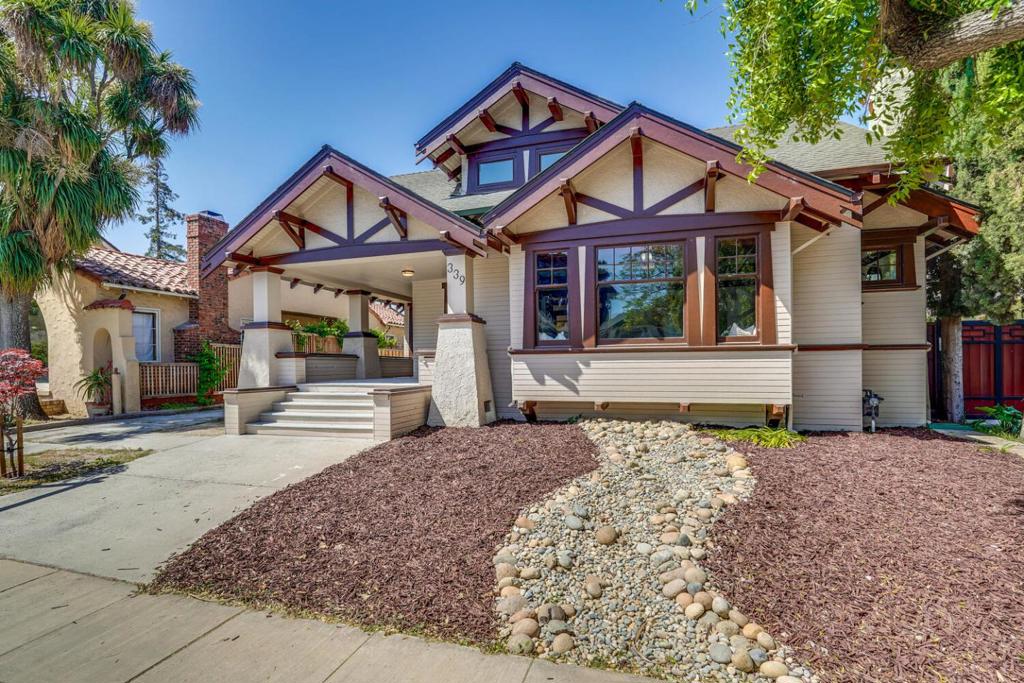 Beautifully restored Craftsman home in the desirable tree-lined Naglee Park neighborhood blends timeless architectural elegance with contemporary comforts. Total 5 spacious bedrooms including two primary suites (one on each level) and 4 fully updated baths. Authentic period details: 9 foot high ceilings, hardwood flooring, coffered ceilings, wainscoting, pocket doors, rich woodwork and custom built-ins showcase exceptional craftsmanship, the beauty of natural materials and historic character throughout the main level. The gourmet kitchen is a chef's dream, featuring custom cabinetry, quartz countertops, a Viking 6-burner gas range, brass pot filler, double oversized sinks (each with its own faucet), a full sized dishwasher and an additional dishwasher drawer for ultimate convenience. Upstairs, a sun-drenched family room with vaulted ceilings offers a bright, modern retreat. Other features include owned solar, double pane windows, new luxury vinyl plank flooring, recessed lighting, central AC/Heating, and copper plumbing. With painstakingly preserved architectural integrity and thoughtfully curated modern enhancements, this home is a rare and seamless fusion of historic charm and contemporary luxury!