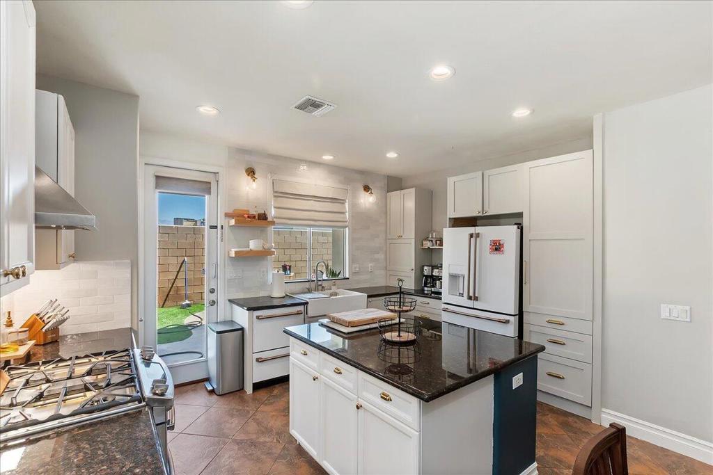 Modern, Remodeled & Low-Maintenance - Move-In Ready Home in Gated Aldea at Jackson!Welcome to 82930 Corte Lucia--an impressively remodeled 3-bedroom, 2-bath home in the highly desirable Aldea at Jackson, a gated community in the heart of Indio. Thoughtfully upgraded with modern design and smart functionality, this single-story home offers both comfort and style.Inside, you'll love the high ceilings, recessed lighting, and a bright, open floor plan perfect for everyday living and entertaining. The remodeled kitchen is a showstopper, featuring granite countertops, a farmhouse sink, modern cabinetry with gold hardware, a beautiful designer tile backsplash, and a spacious center island. The living room offers warmth and charm with a slate-accented fireplace, plantation shutters, and dual climate control via central HVAC plus a ductless mini-split system.Bedrooms are spacious and inviting, including one with Tudor-style wall paneling for a custom, designer touch. The primary suite includes direct backyard access and updated flooring.Step outside to enjoy HOA-maintained front landscaping (a monthly savings!) and a private backyard retreat with premium synthetic grass for year-round greenery and minimal maintenance. Entertain or relax under the covered back patio or the Alumawood pergola just off the primary bedroom, creating two serene outdoor lounging spaces.Aldea at Jackson offers a gated entrance, pool and spa, BBQ area, and low IID electric rates with no Mello-Roos. The location is unbeatable--just minutes to shopping, dining, schools, College of the Desert, and the world-renowned festival grounds.This home checks all the boxes: style, upgrades, efficiency, and location. Don't miss your chance--schedule your private tour today!