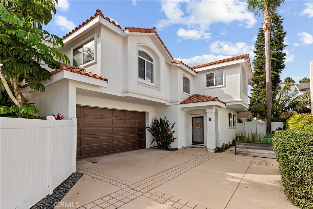 Discover a rare opportunity to own a detached, rear-unit townhome that lives like a single-family home. Nestled on a quiet street, this property offers the perfect blend of comfort, privacy, and charm, all just minutes from the beach. A Home Designed for Modern Living - Enter inside to an open-concept living area, where elegant archways, gorgeous wood floors, and a stacked-stone fireplace create a warm, inviting atmosphere. The renovated kitchen is a true highlight, featuring quartz countertops, a beach-inspired backsplash, and stainless-steel appliances—perfect for both everyday meals and entertaining. A convenient breakfast bar and an intimate dining area provide plenty of space for dining. The main level also includes a laundry room, a powder room with extra storage under the stairs, and direct access to the garage. Unwind and Entertain - Open the doors to the sunny backyard, where you can relax on lazy afternoons or host evening gatherings under the stars, where the private outdoor space is an ideal extension of the home's living area. Your Luxurious Retreat Awaits - Upstairs, you'll find four generously sized bedrooms, all featuring dark wood floors, high ceilings, and ceiling fans. The expansive primary suite is a luxurious retreat, complete with its own fireplace and a large walk-in closet. The spa-like primary bathroom is designed for daily pampering, with a pebbled-floor and a separate bath and shower. Prime Location and Lasting Value - Located within one of the South Bay's top-rated school districts, this home is an ideal choice for families. With no shared walls, a functional layout, and high-quality upgrades throughout, this is a desirable property that won't be on the market for long.