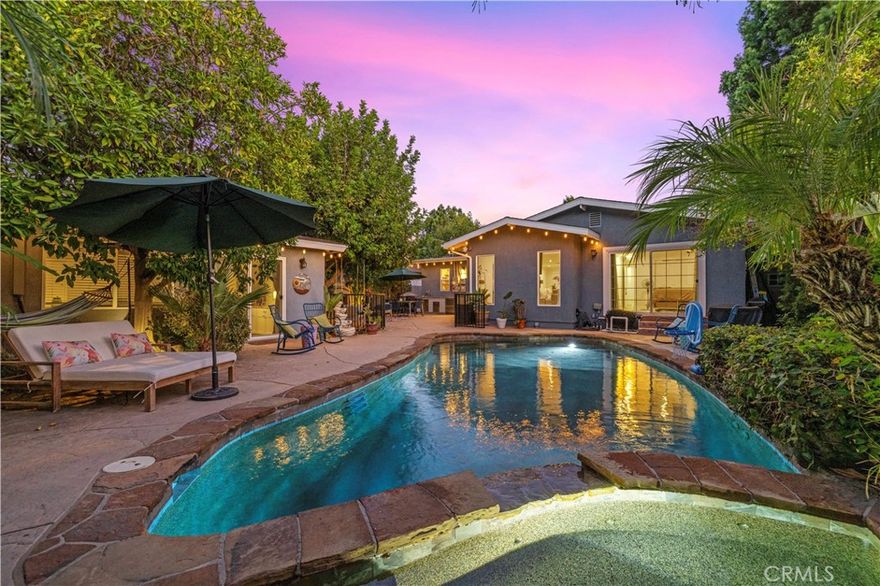 Welcome to this truly special, one-of-a-kind Tarzana home—lovingly designed and meticulously upgraded by the owners with the dream of it being their forever home. Every detail has been carefully considered, and no expense was spared to create a warm, inviting, and functional space that’s perfect for both everyday living and unforgettable gatherings. Featuring 3 bedrooms, 4 bathrooms, and 1,766 square feet of thoughtfully designed living space, plus a 400-square-foot bonus room with its own private entrance, this home offers incredible flexibility—whether for guests, a home office, gym, or creative retreat. Nestled on a spacious 7,194 square foot lot, the open floor plan welcomes you with a light-filled great room, a spacious kitchen with quartz countertops and generous seating, and a cozy dining area perfect for family meals and celebrations. The formal living room invites conversation with its custom-built bar, while the vaulted-ceiling family room—with picture windows and an electric fireplace—creates a serene, heartwarming space that opens effortlessly to the backyard. Step outside to your own private oasis, complete with a sparkling saltwater pool and spa, outdoor shower, mature landscaping, and a fully equipped patio featuring a granite-topped buffet, sink, and outdoor fireplace—ideal for warm evenings under the stars. The primary suite is a peaceful retreat with views of the pool and a luxurious en-suite bathroom featuring a walk-in shower, separate tub, and dual vanity. Throughout the home, you'll find thoughtful touches like recessed LED lighting, natural light vinyl flooring, custom built-in closets, pantry, stackable laundry, guest bathroom and even a privacy hallway door. Additional highlights include a new roof, 31 fully paid-off solar panels, new tankless water heater, retrofitted foundation, new HVAC ducting, shed, upgraded electrical panel and a beautifully finished two-car garage with EV charger and its own bathroom. Surrounded by privacy vinyl fencing and lush, mature trees, this home is more than move-in ready—it’s filled with heart, soul, and years of love, waiting to welcome its next chapter.