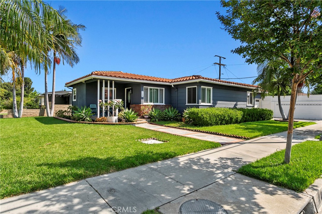 Discover this beautifully updated 3-bedroom, 2-bathroom gem in Anaheim’s sought-after Colony neighborhood. Nestled on a generous 6,160 SF corner lot, this single-level home offers 1,106 SF of stylish living space. Step inside to find vinyl plank flooring throughout, complemented by custom paint and designer lighting that create a warm, welcoming ambiance. The contemporary kitchen boasts custom concrete countertops and a sleek stainless steel sink, perfectly connected to the open-concept living room and cozy dining nook—ideal for both relaxing evenings and lively gatherings. The spacious primary bedroom is joined by two additional bedrooms, offering comfort and flexibility for families or guests. Outside, the expansive patio is an entertainer’s dream: built-in bar with BBQ and sink, firepit, bistro lighting, TV setup, and plenty of room to host unforgettable nights under the stars. Conveniently located within the Anaheim Union School District, and just minutes from major freeways, Disneyland, and top entertainment spots. Don't miss your chance—homes like this don’t come around often. Schedule your private showing today!