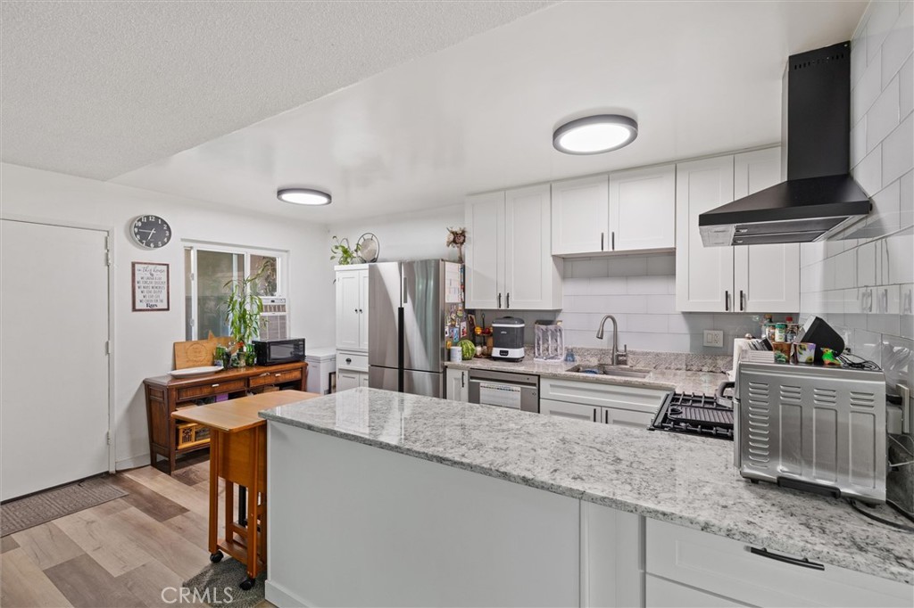 *OVER $75,000 IN CUSTOM UPGRADES !*BEST LOCATION IN THE BUILDING !*TURNKEY !*FRESHLY UPGRADED THROUGHOUT !*LOW HOA !*FHA & VA APPROVED !*GATED COMMUNITY !*This stunning turnkey 2-bedroom, 1-bathroom home is ideally located on the first floor and has been fully upgraded. As you step inside, you’ll immediately notice the two large patios—perfect for outdoor entertaining. The bright and welcoming entryway leads into the spacious living room, featuring new laminate flooring, fresh paint, and modern light fixtures. The chef-inspired kitchen has been completely remodeled with top-of-the-line appliances, custom countertops, and an eye-catching backsplash. The newly remodeled bathroom is equally impressive, with a new mirrored vanity offering extra storage, a custom walk-in shower with designer tile work, and stylish fixtures throughout. The primary bedroom is generously sized with high ceilings and includes a large walk-in closet. The secondary bedroom is also spacious, with ample closet space. Enjoy a wealth of amenities within the HOA, including a sparkling pool, exterior maintenance, gated community, and coverage for water, sewer, and trash. An assigned carport is also included for added convenience. This beautifully upgraded home is just minutes from the beach, the Long Beach Aquarium, upscale shopping, and popular dining spots. It’s centrally located with easy access to freeways, parks, and top-rated schools. Don't miss out on this exceptional opportunity—schedule a tour today!