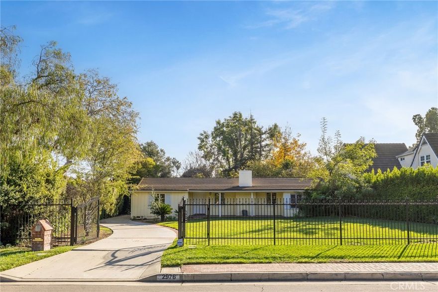 2052 Sq Ft Main Residence + 360 Sq Ft Enclosed Patio | Total 2,412 Sq Ft. Set behind a gated entry on a quiet, tree-lined street, this single-story Pasadena residence offers exceptional privacy, generous scale, and timeless appeal. Situated on an expansive 14,437-square-foot lot, the home provides approximately 2,052 square feet of well-proportioned living space, along with a 360-square-foot enclosed patio and a 195-square-foot room adjacent to the garage that’s ideal for flexible use.

The interior is filled with natural light and features a blend of hardwood, laminate, and tile flooring, complemented by large picture windows throughout. A formal living room, anchored by a classic fireplace, flows effortlessly into the dining area, creating an inviting environment for both daily living and entertaining. A separate family room offers additional living space with peaceful views of the landscaped backyard.

The kitchen is well-appointed with ample cabinetry, generous counter space, and direct access to the rear yard. Three spacious bedrooms include a primary suite with en-suite bath. The bathrooms retain original finishes, offering a unique opportunity to personalize while preserving the home’s authentic character.

Outdoors, the expansive backyard is framed by mature trees and open lawn areas, providing a serene setting with ample room for entertaining, recreation, or future expansion. A detached two-car garage, gated driveway, and adjacent storage/office space add convenience and versatility.

Ideally located near shopping, dining, parks, and major thoroughfares, and within the highly regarded San Marino Unified School District, this property presents a rare opportunity to own a substantial lot with enduring design in one of Pasadena’s most desirable neighborhoods.

3D Virtual Tour Available