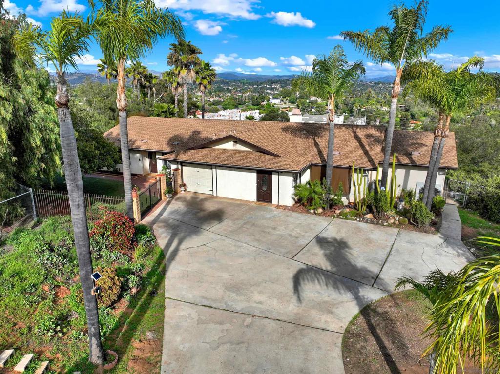 MOUNTAIN VIEWS, LARGE LOT FOR ADU's, MULTI-GENERATIONAL LIVING, NO HOA! Experience tranquil country living & majestic views while only being minutes from city amenities. This exceptional property boasts a remodeled kitchen, fresh interior paint, two large living rooms & an oversized downstairs bonus room with a separate entrance & attached bath. The bonus room creates an ideal guest suite, home office, playroom or optional 5th bedroom. The converted 3 car garage serves as a large personal gym! With 1.2 acres of land there is plenty of space for ADU's, horses, pool or a tennis court. Two incredible highlights are the sun porch - perfect for entertaining & family BBQ's & the back porch to sip your morning coffee or have a quiet dinner al fresco. Enjoy the best of Escondido living with Lake Hodges, Kit Carson Park & Felicita County Park just minutes away. North County Mall, Old Escondido Historic District & even the San Diego Safari Park (just 15 minutes away!) provide shopping, dining & entertainment options nearby. Don’t miss this unique opportunity to own a private retreat with incredible potential!