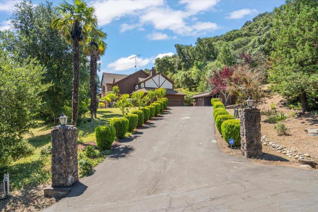 $250,000 PRICE REDUCTION! SELLERS MOTIVATED!! TAKE A SECOND LOOK!! Welcome to this impressive Morgan Hill residence, offering 4,470 square feet of comfortable living space. Situated on a generous 2+ acre lot, this home boasts a gracious formal entry flanking a formal dining and living rooms. The living room features a fireplace and vaulted beamed ceiling. The spacious kitchen has plenty of counter space and storage for a large family. Adjacent is the family room with wet bar, vaulted beamed ceilings, and free standing fireplace with seating. Upstairs are 4 bedrooms including a generous Primary Suite with a step-down sitting area with fireplace. Included is a large Primary Bathroom with separate tub and shower and walk-in closet. The yards are amazing. There's a sparking pool, plenty of deck space, and park-like landscaping. The home also features an indoor laundry room, 4 car garage, and additional covered parking. There's plenty of space and privacy.