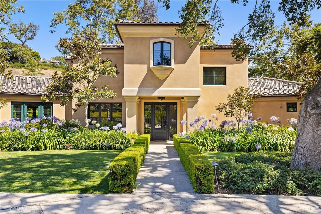 Tucked into one of Montecito's most tranquil enclaves, this elegant Mediterranean residence offers 4 bedrooms and 4 bathrooms on nearly an acre of lavishly landscaped grounds framed by mature oaks and sycamores. The peaceful setting and grand scale of the estate offer quintessential California living just minutes from world-class beaches, dining, shopping, and nature trails. A thoughtfully designed floor plan connects generous interior spaces to a sprawling backyard made for effortless al fresco living. French doors throughout invite natural light and create seamless indoor-outdoor flow. Vaulted ceilings, multiple fireplaces, formal and casual living areas, and an expansive outdoor space perfect for entertaining — this is a great opportunity that blends privacy, design, and location.