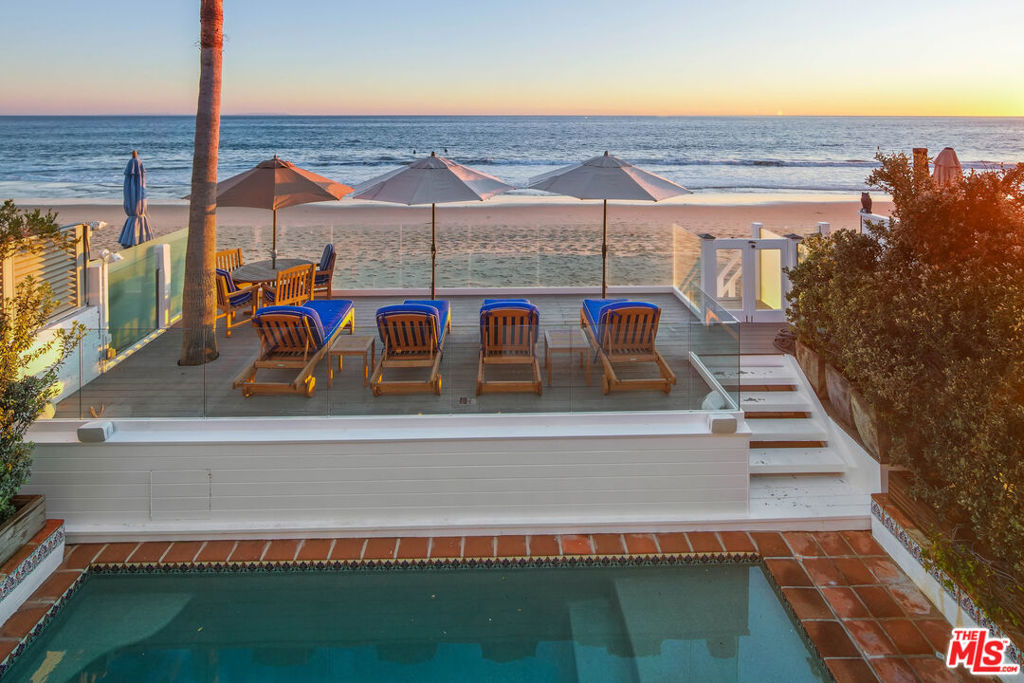 Malibu Colony! Located within the desirable Malibu Colony gated community, on a sandy section of Malibu Colony beach, a rare offering is on the market for the first time in nearly 20 years. With its beach front pool and shabby chic decor, this charming Cape Cod offers the ultimate Malibu experience. Be it a vacation destination or year-round retreat, this five-bedroom residence provides serene, seaside accommodations that instantly capture your emotions. The open floor plan offers several sitting areas to entertain, dine, relax or watch TV. The charming kitchen allows the home or visiting chef to work their magic in an inviting environment. The generous primary suite pleasantly pampers with its two sitting areas, office area, spectacular ocean views, spacious bath and walk-in closet. Visiting family or guests can enjoy the privacy of separate bedrooms connected by a common sitting area. The large third level guest suite has skylights and impressive space for lounging away from the central entertaining hub of the home. Entertain friends or relax on the spacious, Saltillo-tiled beach front patio, complete with dining and lounging areas or relax inside the Spanish tile accented pool. Experience the ultimate Malibu Colony lifestyle in this Malibu Colony gem.