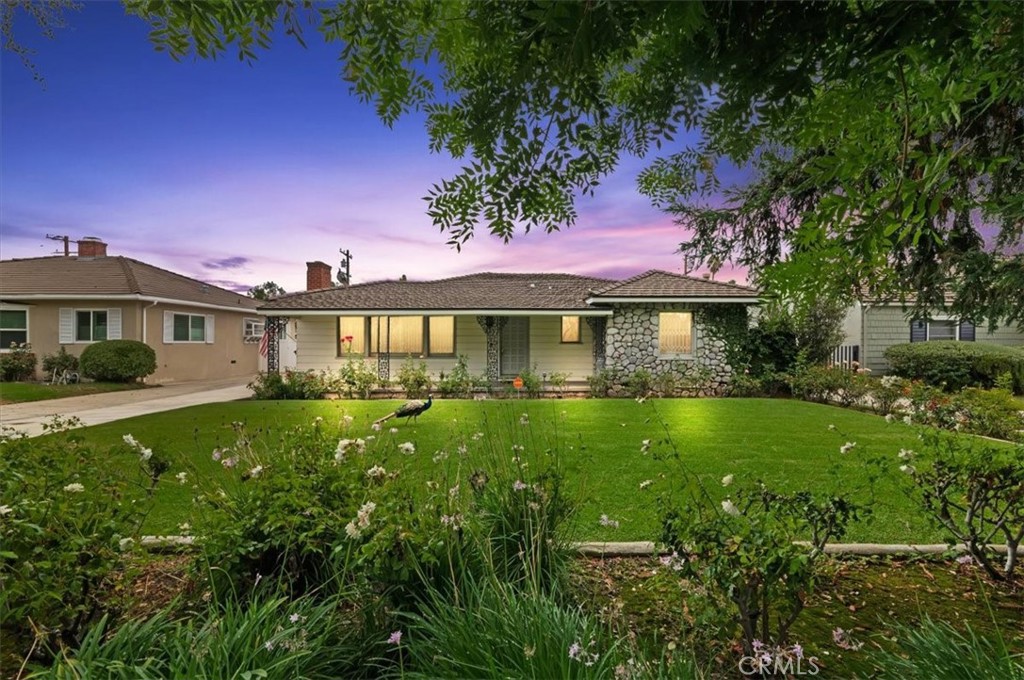 Welcome to 412 S Old Ranch Road, a beautifully updated home in the heart of Arcadia offering timeless curb appeal and modern comfort. From the inviting front porch to the lush landscaped grounds, this residence combines classic charm with thoughtful upgrades. Step inside to a bright and spacious living room featuring large picture windows and a warm, welcoming flow into the dining area. The updated kitchen with newer stone countertops, stainless steel appliances, and ample storage, seamlessly connecting to an additional dining nook and mudroom for everyday convenience. The primary suite offers a relaxing retreat with a walk-in closet and a spa-inspired bathroom complete with a dual vanity, soaking tub, and walk-in shower. Additional bedrooms are generously sized, providing versatility for family, guests, or office use. Outdoors, enjoy beautifully maintained landscaping, a private backyard perfect for entertaining or future expansion. A two-car garage and spacious driveway provide ample parking. Situated on a quiet street in a sought-after Arcadia neighborhood, this home places you near award-winning schools, shopping, dining, and local parks. Updated sewer line, updated appliances, amazing potential with classic 1940s charm.