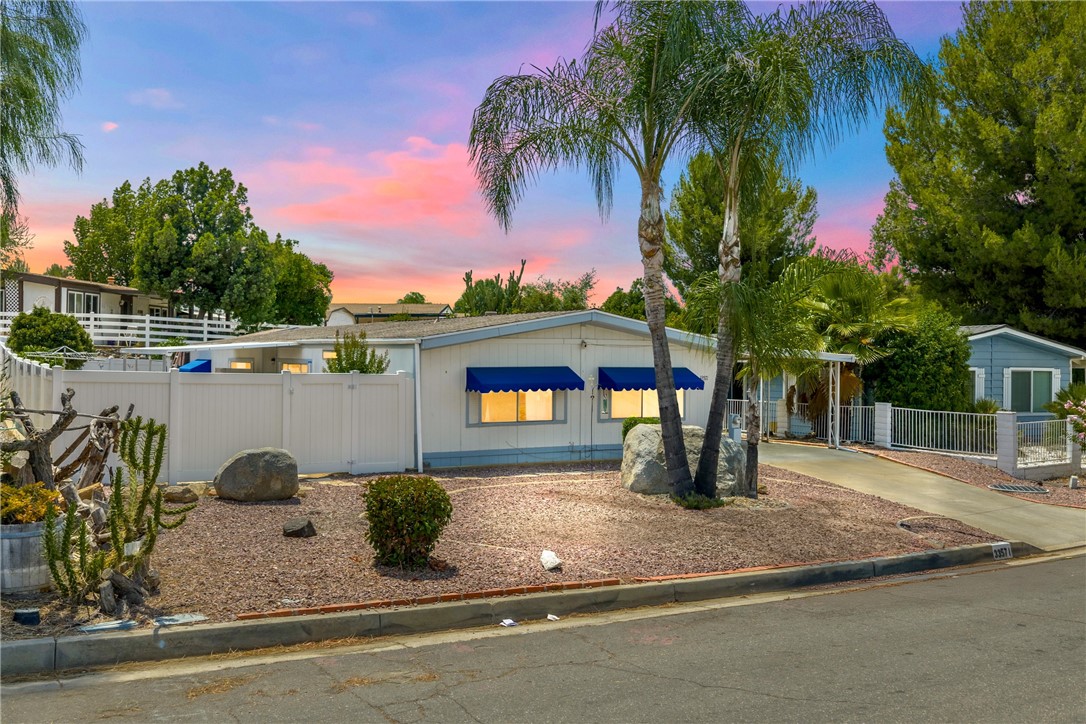 Discover Your Dream Home in Wildomar’s Most Coveted Community! Welcome to The Farm, one of Wildomar’s most desirable neighborhoods—family-friendly, amenity-rich, and ideally located between the 15 and 215 freeways for easy commuting. Residents enjoy an impressive lineup of amenities, including three pools and spas, a clubhouse, basketball and tennis courts, a dog park, community gardens, scenic hiking trails, fishing ponds, and even RV storage—all for a low monthly HOA fee.
This upgraded 3-bedroom, 2-bath home sits on owned land with a permanent foundation, offering long-term value, comfort, and peace of mind. Inside, you’ll love the highly functional layout: the private primary suite is thoughtfully separated from the guest bedrooms and expansive great room, perfect for families or shared living. Recent updates include a new roof, a reinforced and leveled foundation, luxury vinyl plank flooring in the main areas, and plush carpet with upgraded padding in the bedrooms and living room. The kitchen features modern appliances, and a generously sized laundry room makes everyday living easier. Outside, enjoy a newly installed PVC gated yard—ideal for pets, entertaining, or simply relaxing while taking in the mountain views. A large 10×24 workshop/shed adds extra utility, and the covered carport easily fits two vehicles.
Whether you’re a first-time buyer, downsizing, or investing, this move-in-ready gem delivers the perfect blend of privacy, practicality, and lifestyle. Don’t miss your chance to be part of The Farm—where community meets comfort.