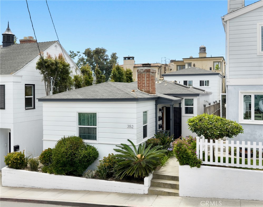 Discover prime coastal living at 352 27th Street, perfectly positioned equidistant to the Hermosa and Manhattan Beach Piers. This Hermosa Beach single family home on a full ocean view lot is just two blocks from the beach and one house off of the beautiful and lush Valley Park. The charming cottage features two bedrooms and one bathroom, with a cozy fireplace anchoring the light-filled living room. Modern upgrades throughout make this home move-in ready, while preserving its original warmth and character.
The bonus room above the two-car garage offers serene park views and is complete with a full bathroom and kitchenette—ideal for guests, a home office, or creative studio space. A private backyard patio invites morning coffee in the sunshine or a cocktail under the stars.
Step outside and stroll down to local favorites like Gitana Café and Martha’s, grab essentials at The Green Store, or enjoy dinner at Slay Hermosa or the Bottle Inn. The 27th Street corridor offers a perfect balance of tranquility and accessibility, making it an ideal location for both full-time residents and those seeking a beach retreat.
Whether you're looking to invest, move in, or build your forever home, this location delivers with its unbeatable combination of beach proximity, coastal charm, and South Bay lifestyle. Experience the best of Southern California beach living at 352 27th Street, where every day feels like a vacation and the beach is your backyard.