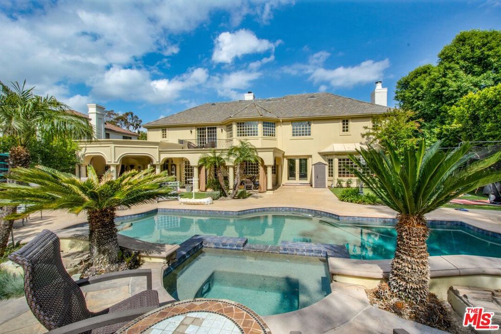 Priced to Sell! Welcome to this spectacular 6,252 sq ft estate in the prestigious guard-gated community of Mountain View Estates. This rare and highly upgraded Plan 6 residence exudes luxury at every turn, featuring brand-new walnut wood flooring, a smart-controlled saltwater pool and spa, and a completely redesigned primary suite. Step through grand wrought iron doors into a dramatic entryway with a sweeping staircase, setting the tone for the elegant living spaces beyond. The open floor plan flows effortlessly through the main level, with custom coffered ceilings, a stylishly updated living room fireplace, surround sound, and abundant natural light throughout. The gourmet kitchen is a chef's dream equipped with premium Viking appliances, granite countertops, and a large walk-in pantry overlooking the beautifully landscaped backyard. The home offers six spacious en-suite bedrooms, including a show-stopping primary retreat with a romantic sitting area, two custom walk-in closets, a Bain Ultra aromatherapy tub, steam shower, and Toto smart toilet. Step outside to your private resort-style oasis, featuring a covered loggia, built-in BBQ island, firepit, rose garden, and space for a gym or garden shed all perfect for entertaining or unwinding. Located on a quiet street within the award-winning Las Virgenes School District and minutes from Malibu beaches, The Commons, and top private schools, this move-in ready home is a rare find in one of Calabasas' most coveted communities. A must-see for discerning buyers.