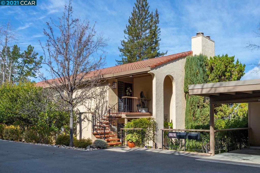 This elegant, updated Villa Francisco features Spanish architectural influence with masonry roof tile roofs and graceful arches. This sought-after spacious floor plan is surrounded by large windows, abundant natural light, and amazing panoramic views with a townhouse feel (upper level with no shared walls!) and an extra-long balcony that runs the entire length of the home, perfect for relaxing, gardening, entertaining, and exercise! The kitchen features a large pantry and breakfast nook. The large and gracious living room is perfect for entertaining featuring a gorgeous marble framed gas fireplace, hearth, and wet bar with lovely hill and tree views. Relax in your gigantic owner’s suite with ensuite bath and mirrored closet doors that bring gorgeous views into the room! 3rd bedroom or home office. Enjoy abundant closet space, ample storage on the deck as well as in two carport closets. The extra-large covered parking space is immediately adjacent to the front steps of your Villa.