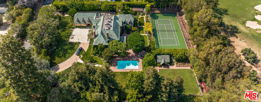 Located on one of the most desirable streets in all of Los Angeles, this estate is on an all useable 1.45 acres with 210 ft frontage on the 14th hole of the famed Los Angeles Country Club. The 1930's Country English home was remodeled in 1979 and is now available for sale for the first time in decades. The home is 7,826 sf ft and the property includes a sunny pool, huge lawns, and a N/S lighted tennis court bordering the country club. The property is totally private and gated with a circular drive and parking for many cars beyond the 4 garages. This is a once in a generation opportunity to either remodel an existing home or build a new dream "final" estate for the most sophisticated of buyer and in a neighborhood flush with 9-digit valued homes.