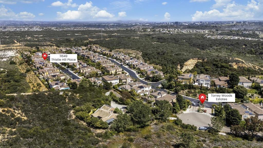Welcome to 11649 Thistle Hill, nestled in the exclusive gated community of Torrey Woods Estates. This exceptional home offers the unique advantage of choice between two top-rated elementary schools: Ocean Air or Torrey Hills. Gated courtyard entry invites you into a freshly painted home with designer finishes. Grand formal entry with cathedral ceilings open to the elegant formal living and dining rooms with dual-sided fireplace. New luxury vinyl plank flooring, custom lighting, and an abundance of natural light throughout. The chef’s kitchen is a true showstopper, featuring an oversized island with prep sink, pendant lighting, Quartz countertops, a spacious eat-in area, walk-in pantry, built-in desk, premium Viking appliances including a 6-burner cooktop with hood and professional-grade refrigerator—all seamlessly flowing into the family room with fireplace. Private backyard landscaped with gorgeous, mature greenery and low-maintenance turf—perfect for relaxing or entertaining. First floor offers a full en-suite bedroom, custom wine cellar, powder room with new vanity plus a versatile bonus room perfect as an office or playroom. Upstairs, you'll find a massive bonus room with custom French glass doors, offering additional space for a second office, media room, or lounge. Expansive primary suite features a generous sitting area and a spa-inspired bathroom with dual vanities, soaking tub, walk-in shower, bidet toilet, and large walk-in closet. Two additional beds, a full bath, and a spacious laundry room with linen storage complete the second floor. Additional upgrades include EV car charger, smart locks & Nest thermostats, updated kitchen countertops, sinks, and fixtures, new flooring, paint, lighting, turf and professional landscaping. All this in a premier location just minutes from Torrey Pines Beach, One Paseo, shopping, dining, and within the top-rated Del Mar Union and San Dieguito Union High School Districts. Don’t miss the opportunity to call this extraordinary home yours!