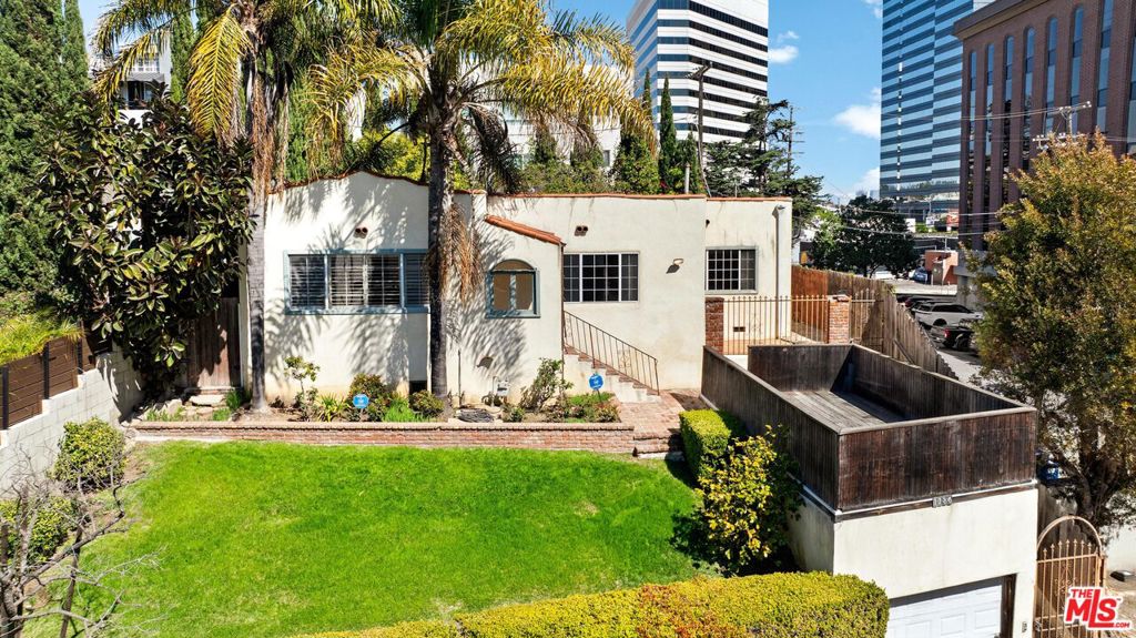 Perched above street level for enhanced privacy, this 3-bedroom, 3-bathroom, Spanish-style home, spans 1,538 sq. ft. on a 5,339 sq. ft. lot, offering a fantastic opportunity for buyers looking to add their personal touch. With its inviting open floor plan, the home welcomes you with a bright and spacious living room that flows seamlessly into the dining area and kitchen. A pass-through counter with barstool seating makes entertaining easy, while the kitchen opens directly to the backyard, providing a great indoor-outdoor connection. Off the kitchen, you'll find a separate laundry room and an additional full bathroom for added convenience. The primary suite is generously sized, featuring a walk-in closet and an en suite bathroom with a dual sink vanity and a shower over tub. Down the hall are two guest bedrooms which share a bathroom. While the home needs TLC, it presents a rare opportunity to restore its character and charm. Situated in a highly desirable Brentwood location, you're just moments from Brentwood's Farmers Market, Brentwood Country Club, and an array of shops and restaurants all within walking distance. Offered as-is, this is a fantastic chance to create your dream home in a sought-after neighborhood.