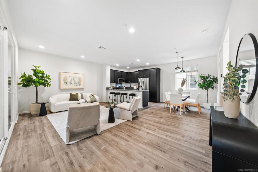 FHA & VA approved! Welcome to this a light & bright 3-story townhome featuring a neutral color palette, stylish wide-plank flooring, an open-concept main level offering a modern kitchen with breakfast bar, perfect for casual dining & entertaining and a balcony for morning coffee or evening relaxation. Retreat to the spacious primary suite with large bath and walk-in closet.  Access to wonderful community amenities including a sparkling pool, spa, and park/recreation area. Conveniently located to shopping & dining and easy freeway access! Modern living meets effortless comfort in this beautifully designed home!