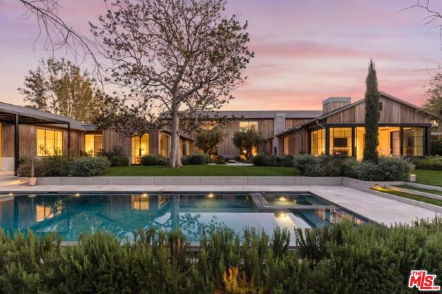 Located in Holmby Hills on Carolwood Drive emerges the Grey Estate. Gates draw open and spill onto picturesque 2.15 acre canvas of lush gardens & grounds. Architect, Howard Backen, blends nature & design into a seamless interior/exterior connection. Steel & glass paneled doors disappear in rooms creating the ultimate in California living. Landscape by Miranda Brooks. Design by Atelier AM, reflects proportioned spaces rendered in sensuous materials. Luxurious master suite w/ generous his/her bathrooms & Century City views. 4 addtl en suite bdrms. Voluminous living room transforms into a studio quality theater, stylish den w/ bar & private office. Wooded barn like great room includes open kitchen, dining area, large family & sun room. Windowed walls slide away to a center courtyard, outdoor dining area, fruit orchard & vegetable/herb garden. 2-story rec facility w/ twin gyms, cold plunge, steam room & sauna steps away from pool & spa. A sense of intimacy, warmth & informality pervades.