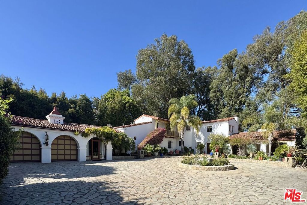 Tucked away on one of Brentwood's most prestigious streets, 334 N. Carmelina Ave is on the market for the first time in over fifty years. Beyond a private gate, the estate offers a rare combination of timeless elegance, unparalleled privacy, and boundless potential. Set on an expansive approximately 3/4-acre lot, this secluded retreat showcases striking Spanish architecture, with a long, tree-lined driveway leading to a grand motor court. The property offers the perfect balance of tranquility and beauty, providing a peaceful sanctuary just moments from the best amenities Brentwood has to offer. The sprawling yard is a true oasis: at the center of this outdoor retreat is a sparkling pool, with areas ideal for cooking, al fresco dining, lounging, or hosting gatherings a true entertainer's dream. The generous lot size also offers ample room for the addition of a tennis court, further enhancing the recreational possibilities of the space. Additionally, the property presents endless opportunities for redevelopment or the creation of a completely new estate. Noteworthy as well is the view of the iconic Getty Museum from the back of the property. Perfectly situated in the heart of Brentwood, 334 N. Carmelina Ave offers effortless access to the best of the west side. Just minutes from world-class dining, boutique shopping, and renowned entertainment options in Brentwood Village, this location provides unparalleled convenience. 334 N. Carmelina Ave is more than just a propertyit's a rare offering that combines privacy, prestige, and limitless potential. Whether you are inspired by the existing home's Spanish charm or envisioning a brand-new creation, this exceptional property invites you to imagine a life of unparalleled elegance in one of Los Angeles' most coveted neighborhoods.