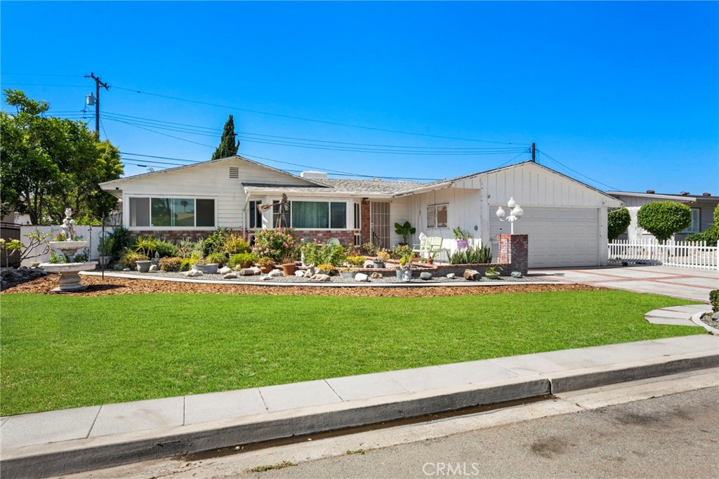 Welcome to 9802 Swallow Lane, a charming single-story home located on a quiet, established street in the heart of Garden Grove. This well-maintained residence features 4 bedrooms, 2 bathrooms, and approximately 1,640 square feet of living space on a spacious 7,200 square foot lot. Inside, you'll find two inviting living areas—each with its own fireplace. The formal living room offers a bright bay window and a classic brick hearth, while the expanded family room features dramatic open-beam ceilings, a skylight, a floor-to-ceiling stone fireplace, and warm wood-style flooring. The kitchen includes tile countertops, recessed lighting, and a generous amount of cabinetry. A large passthrough with bar seating connects the kitchen to the family room, creating a functional and social layout perfect for entertaining while maintaining defined space. Off the family room, a versatile breezeway offers additional living flexibility—ideal for a hobby room, workout space, or extra storage. Additional highlights include a attached 2-car garage, an extended driveway, and a private backyard ready for gardening or outdoor gatherings. Close to schools, parks, shopping, and major freeways, this home blends comfort, character, and convenience in one of Garden Grove’s most desirable neighborhoods.