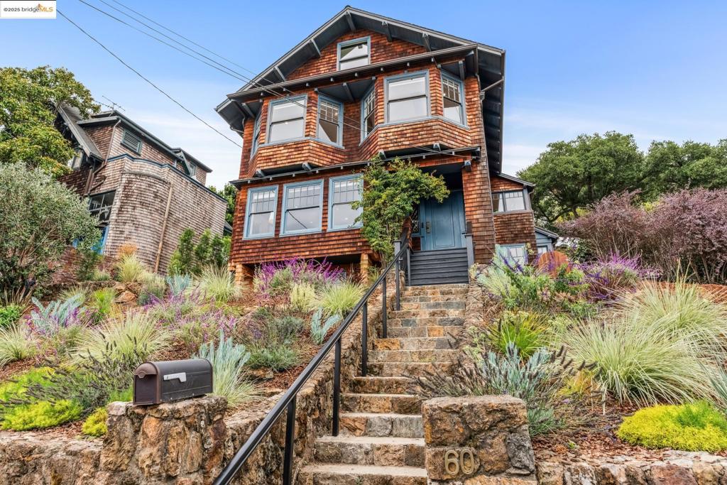 Discover the timeless allure of the William J. Moore House. This historic Craftsman masterpiece, crafted by Henry Rowe, is part of the esteemed Panoramic Hill National Register Historic District and has the Mills Act designation. This home exudes elegance with its natural brown wood shingles, clinker-brick chimneys, and distinctive front gable roof. A notable front volcanic rhyolite wall contributed to its historic status. Inside are many period details. The spacious living room entered via retractable French doors boasts a massive fireplace, a Steuben-style ceiling fixture and stunning San Francisco Bay views. The formal dining room and updated kitchen with access to outdoor spaces. The second floor features a large luxurious primary suite with panoramic bay views, two additional bedrooms, two updated baths, a lovely sunroom and back yard access. Ascend to the finished attic for a cozy den, extra bedroom/bath and the finished non-conforming lower level has a private entrance, kitchenette, sleeping space/office, bath and storage. Meticulously updated for modern living, this home blends historic charm with contemporary comforts. Welcome to elegance, views and history. Views: Downtown