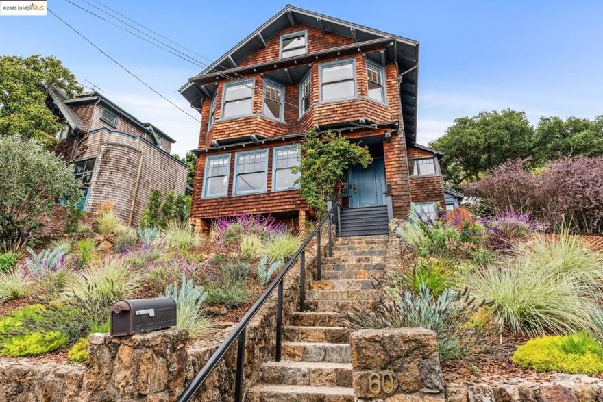 Discover the timeless allure of the William J. Moore House. This historic Craftsman masterpiece, crafted by Henry Rowe, is part of the esteemed Panoramic Hill National Register Historic District and has the Mills Act designation. This home exudes elegance with its natural brown wood shingles, clinker-brick chimneys, and distinctive front gable roof. A notable front volcanic rhyolite wall contributed to its historic status. Inside are many period details. The spacious living room entered via retractable French doors boasts a massive fireplace, a Steuben-style ceiling fixture and stunning San Francisco Bay views. The formal dining room and updated kitchen with access to outdoor spaces. The second floor features a large luxurious primary suite with panoramic bay views, two additional bedrooms, two updated baths, a lovely sunroom and back yard access. Ascend to the finished attic for a cozy den, extra bedroom/bath and the finished non-conforming lower level has a private entrance, kitchenette, sleeping space/office, bath and storage. Meticulously updated for modern living, this home blends historic charm with contemporary comforts. Welcome to elegance, views and history. Views:  Downtown
