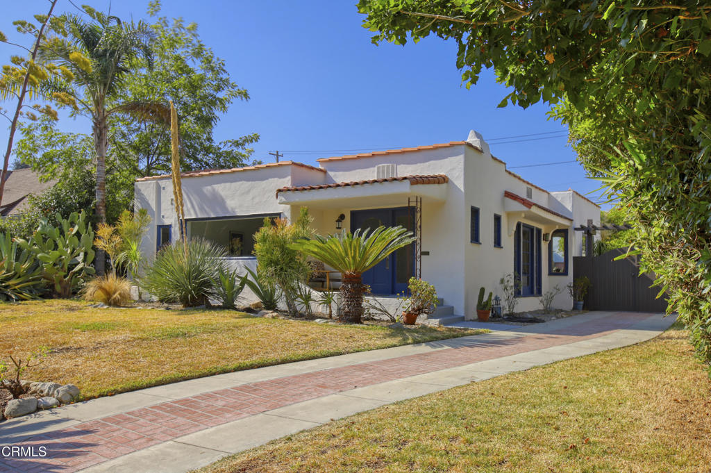 Eldora Road is one of my favorite streets in Pasadena. Not because I've called it home for the last 22 years but because of the sense of community that exists here. The assortment of character homes, meandering sidewalks, vintage streetlights, and mature trees are unique and beautiful, but the people that live here are what make it truly something special.Back in 1925, architect Glen Elwood Smith designed a Spanish style home at 575 Eldora Road. The two-bedroom floor plan consisted of 1,656 square feet on a large 8,047 square foot parcel. It is unknown if his original design included the front sitting area off the living or the 2nd bathroom connected to the rear bedroom, but regardless those have certainly enhanced the home. The formal entry includes a Batchelder tiled faux fireplace and built-in bookcases and opens into the spacious living room. The living room offers large picture windows, another Batchelder tiled fireplace, and hardwood flooring. The sitting area includes Saltillo tile and a window that extends from one side of the wall to the other. Off the central hallway are the two bedrooms and full bathroom. Each room is nicely sized with original double hung wood windows and wall sconces. The kitchen is updated with granite counters and wood cabinets and has access to the California basement. The dining room is quite charming with multiple windows and views of the rear yard.Both the front and rear yards offer drought resistant plants and are ready for the new owner to bring back the green grass and award-winning landscape. The rear yard also includes a Pergola, a sitting area, and a two-car detached garage.