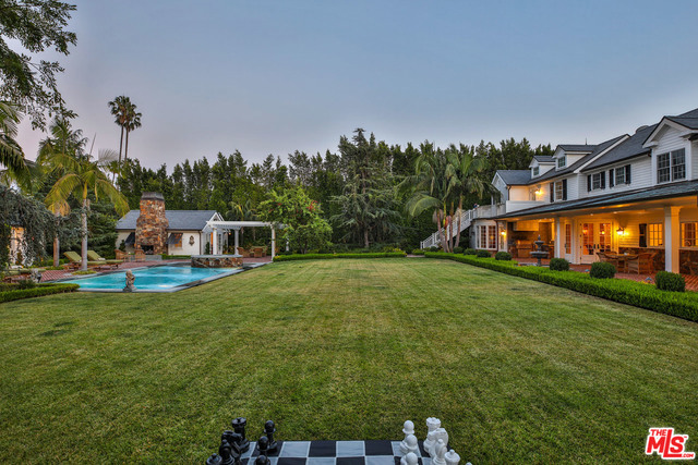 Seldom does a home of this caliber grace our market. Situated on over 30,000 square feet of flat land with complete privacy, this 11,000 square ft Cape Cod masterpiece must be seen to be fully appreciated. Greenway Manor features an open floor plan with a capacious great room connecting the main living spaces and backyard beyond. The recently upgraded kitchen is a chef's dream- complete with professional grade appliances and an oversized kitchen island, which open to the dining and living spaces. Features include 7 en-suite bedrooms, 10 custom bathrooms, gourmet kitchen, wood paneled office, home theatre and much more. The classic Beverly Hills palm trees set a serene backdrop to the ultra-private & beautifully landscaped grounds complete with a built-in BBQ, pool & spa, charming guest casita, private gym, verdant lawns & gardens, covered loggias, lighted sports court, 2-car garage and motor court.